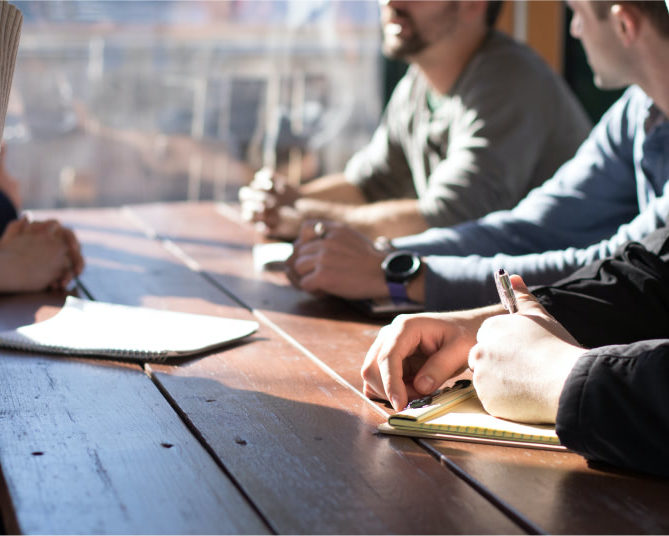 People sitting at a conference table it support companies vermont